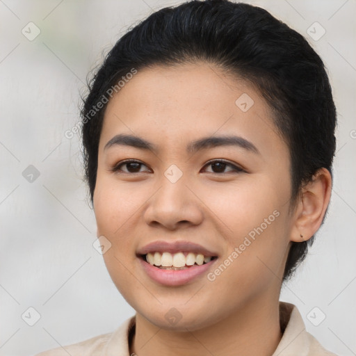 Joyful asian young-adult female with short  brown hair and brown eyes