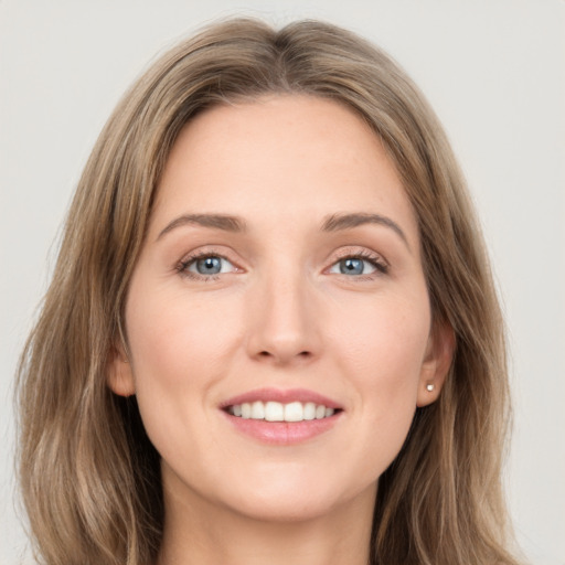 Joyful white young-adult female with long  brown hair and grey eyes