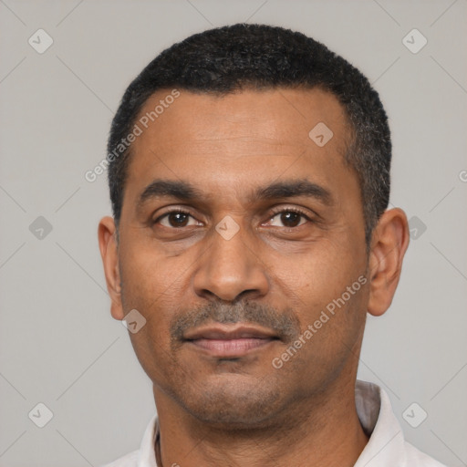 Neutral latino adult male with short  black hair and brown eyes