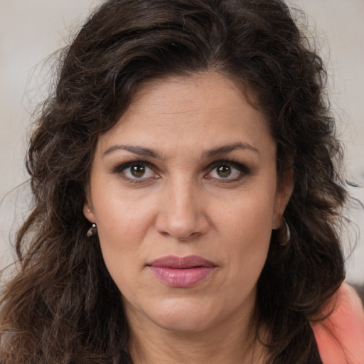 Joyful white adult female with long  brown hair and brown eyes