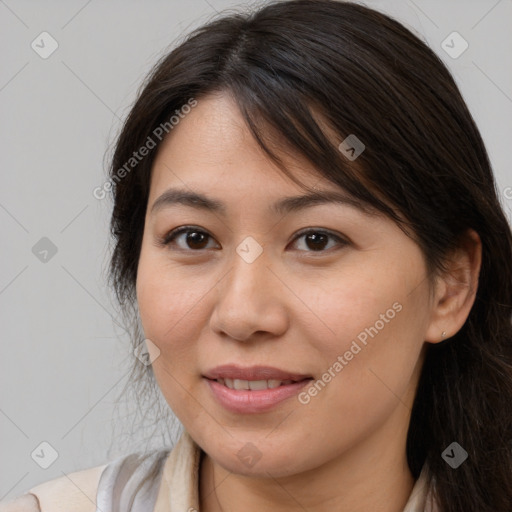 Joyful white young-adult female with long  brown hair and brown eyes