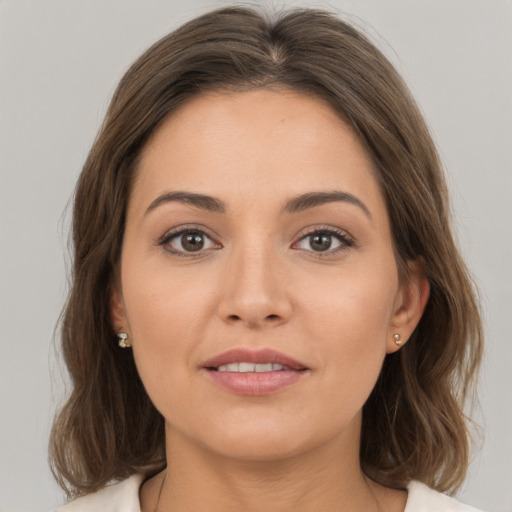 Joyful white young-adult female with medium  brown hair and brown eyes