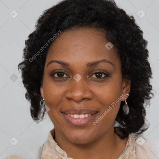 Joyful black adult female with medium  brown hair and brown eyes