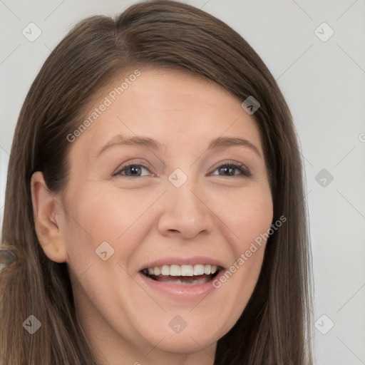 Joyful white adult female with long  brown hair and brown eyes