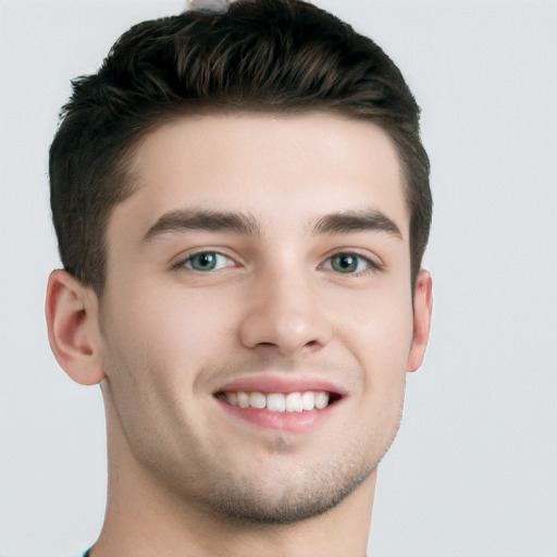 Joyful white young-adult male with short  brown hair and grey eyes