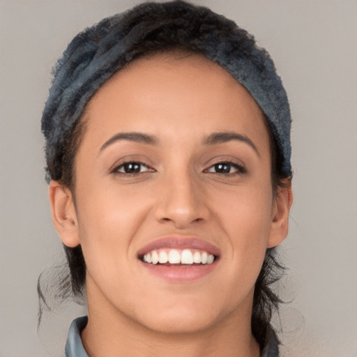 Joyful white young-adult female with long  black hair and brown eyes