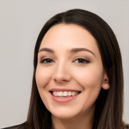 Joyful white young-adult female with long  black hair and brown eyes