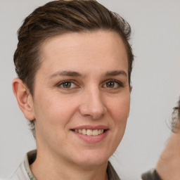 Joyful white adult female with short  brown hair and brown eyes