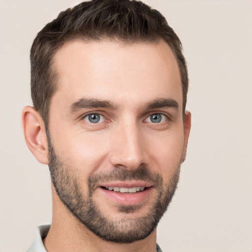 Joyful white young-adult male with short  brown hair and brown eyes