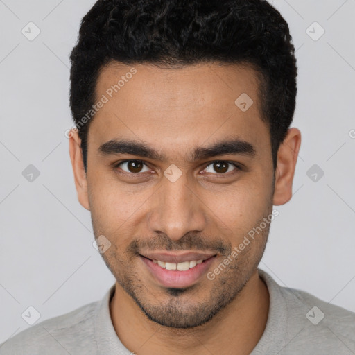 Joyful white young-adult male with short  black hair and brown eyes