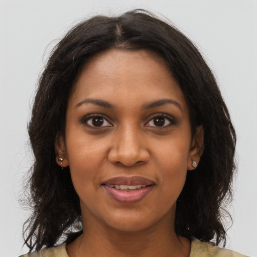 Joyful black young-adult female with long  brown hair and brown eyes
