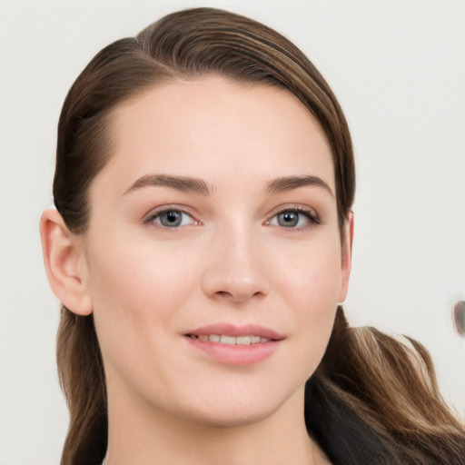 Joyful white young-adult female with long  brown hair and grey eyes