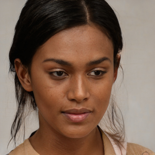 Neutral black young-adult female with medium  brown hair and brown eyes
