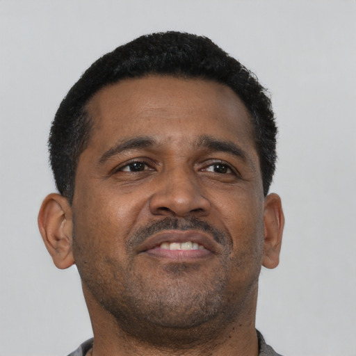 Neutral latino adult male with short  black hair and brown eyes