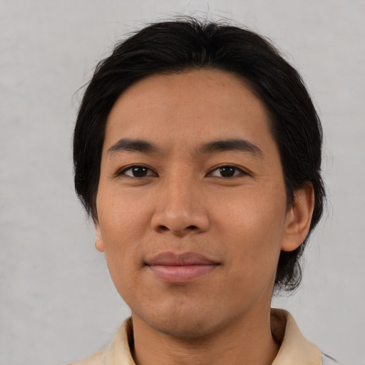 Joyful asian young-adult male with medium  brown hair and brown eyes