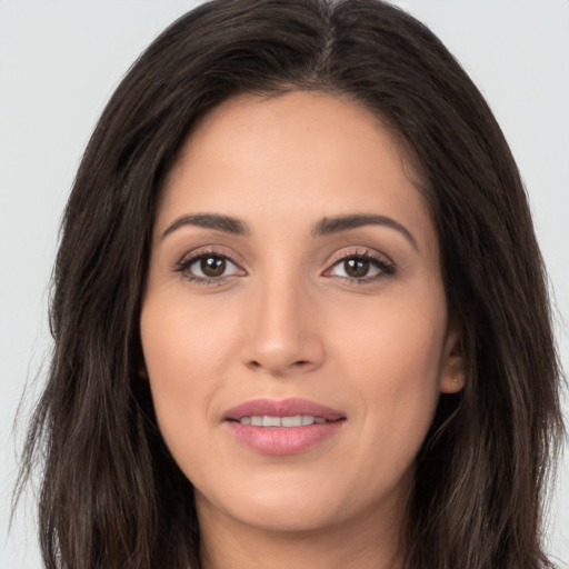 Joyful white young-adult female with long  brown hair and brown eyes