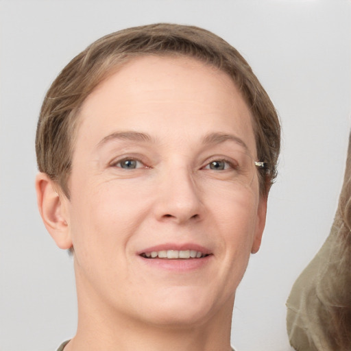 Joyful white adult female with short  brown hair and grey eyes