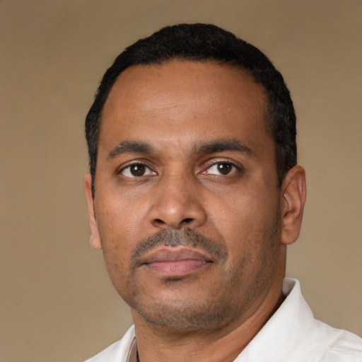 Neutral latino adult male with short  black hair and brown eyes