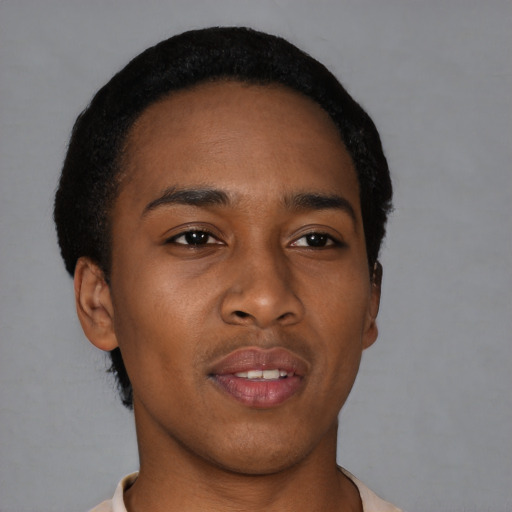Joyful black young-adult male with short  black hair and brown eyes