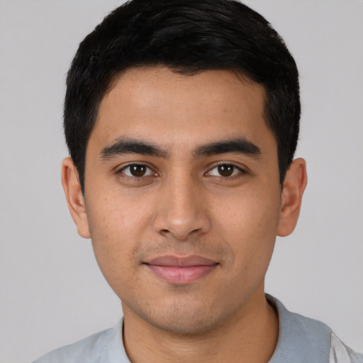 Joyful latino young-adult male with short  black hair and brown eyes