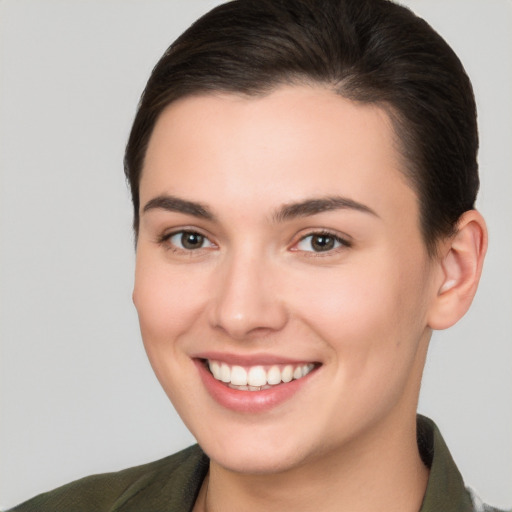 Joyful white young-adult female with short  brown hair and brown eyes