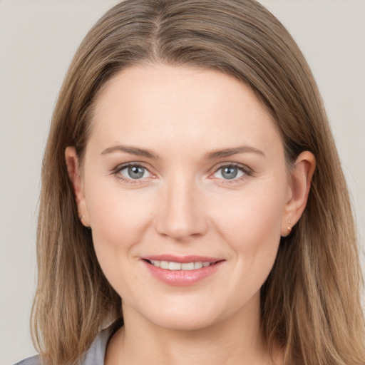 Joyful white young-adult female with long  brown hair and grey eyes