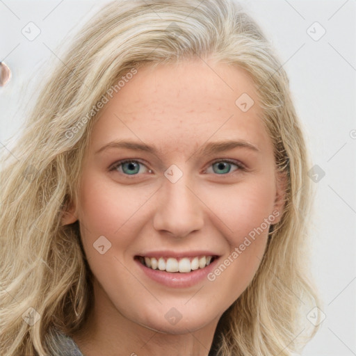 Joyful white young-adult female with long  brown hair and blue eyes