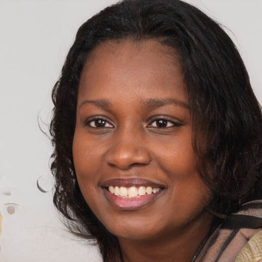 Joyful black young-adult female with medium  brown hair and brown eyes