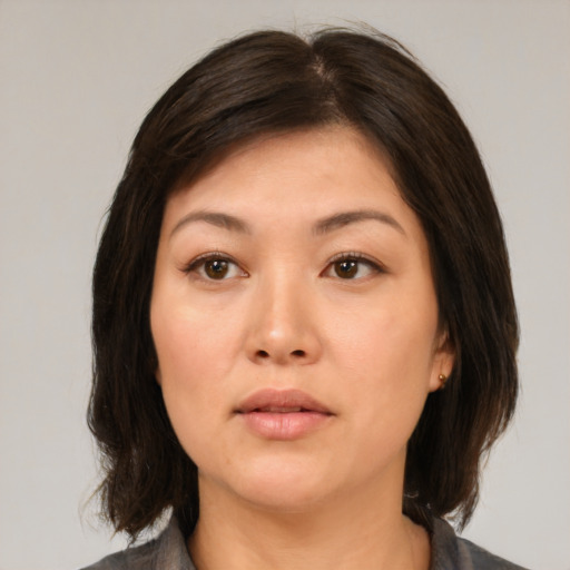Neutral asian young-adult female with medium  brown hair and brown eyes
