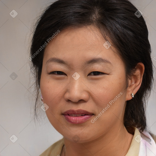 Joyful asian adult female with medium  brown hair and brown eyes