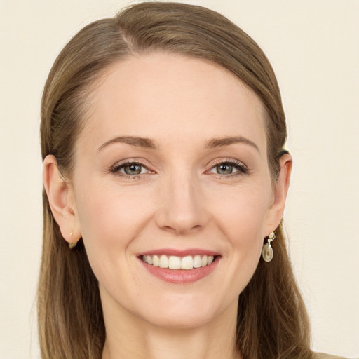 Joyful white young-adult female with long  brown hair and blue eyes