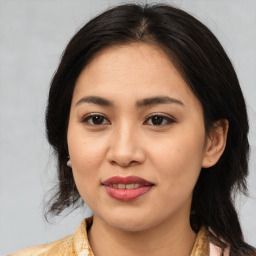 Joyful asian young-adult female with medium  brown hair and brown eyes