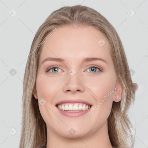 Joyful white young-adult female with long  brown hair and blue eyes