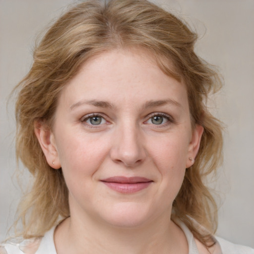 Joyful white young-adult female with medium  brown hair and blue eyes