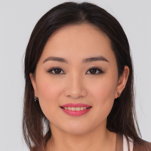 Joyful asian young-adult female with long  brown hair and brown eyes