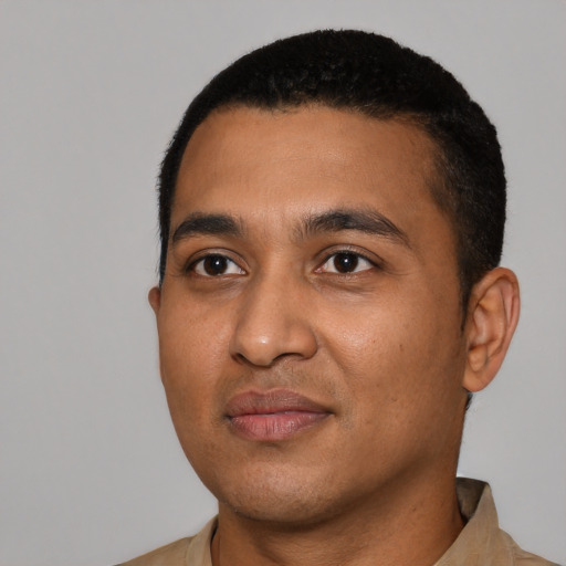Joyful latino young-adult male with short  black hair and brown eyes