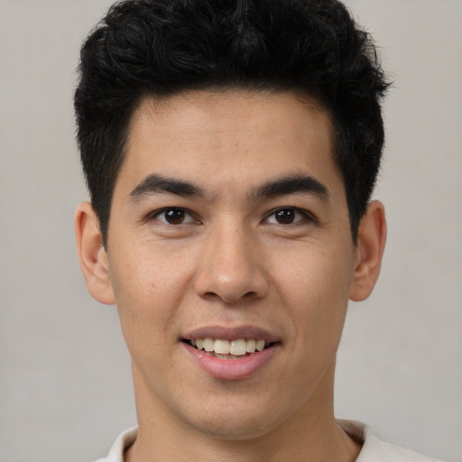 Joyful latino young-adult male with short  brown hair and brown eyes