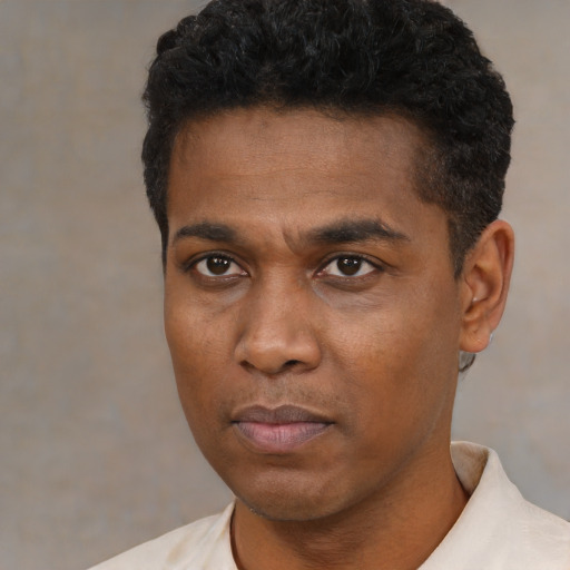 Neutral black young-adult male with short  black hair and brown eyes