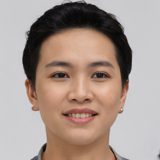 Joyful asian young-adult female with short  black hair and brown eyes