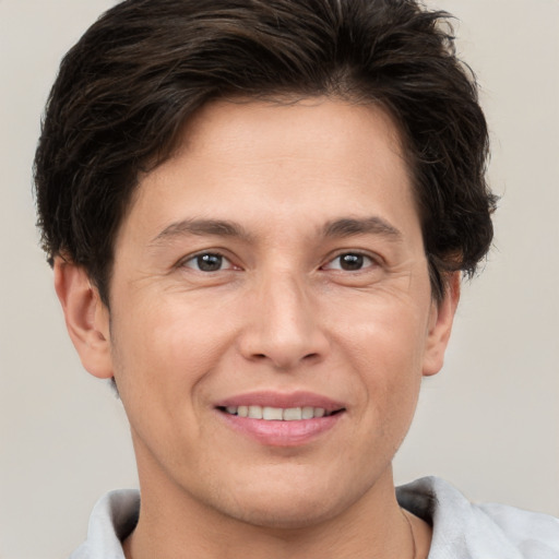 Joyful white adult male with short  brown hair and brown eyes