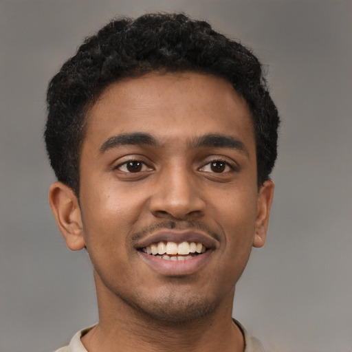 Joyful latino young-adult male with short  brown hair and brown eyes