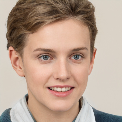 Joyful white young-adult female with short  brown hair and blue eyes