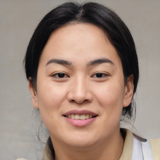 Joyful asian young-adult female with medium  brown hair and brown eyes