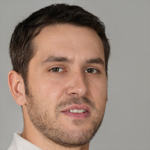 Joyful white adult male with short  brown hair and brown eyes