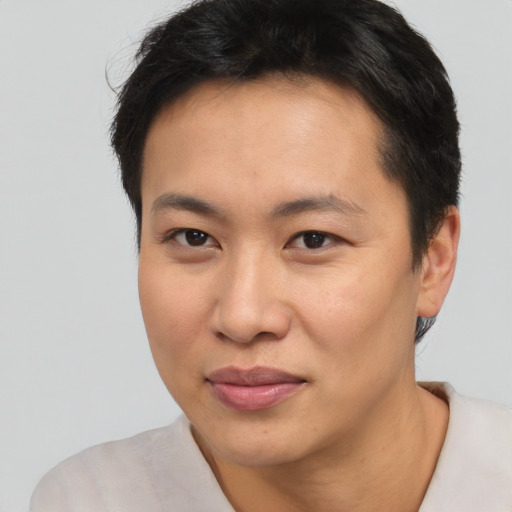 Joyful asian young-adult female with short  brown hair and brown eyes