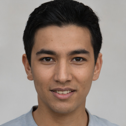 Joyful asian young-adult male with short  black hair and brown eyes