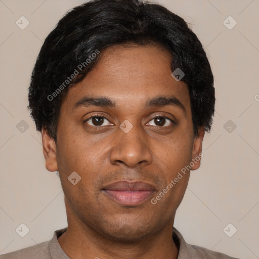 Joyful black young-adult male with short  black hair and brown eyes