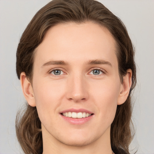 Joyful white young-adult female with medium  brown hair and grey eyes