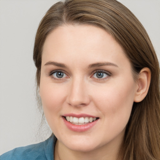 Joyful white young-adult female with long  brown hair and grey eyes