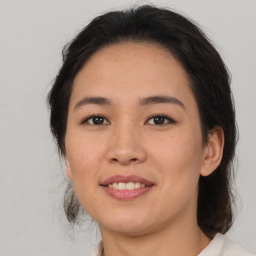 Joyful latino young-adult female with medium  brown hair and brown eyes